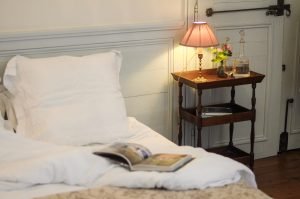 Lit bed and bedside table of Mademoiselle's room atmosphere