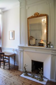 View of the large mirror placed on the fireplace in Mademoiselle's bedroom